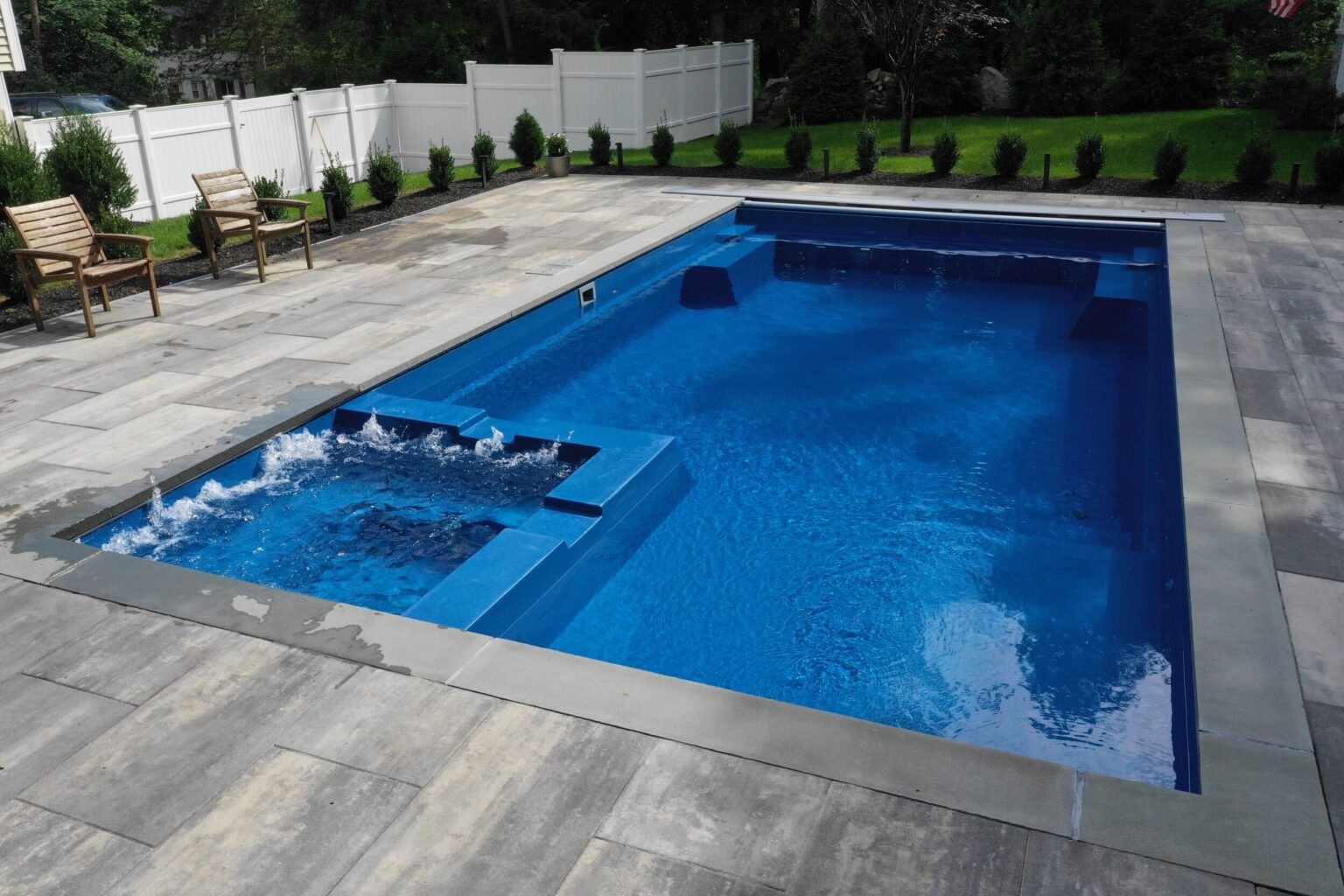 Large fiberglass swimming pool installation on project site